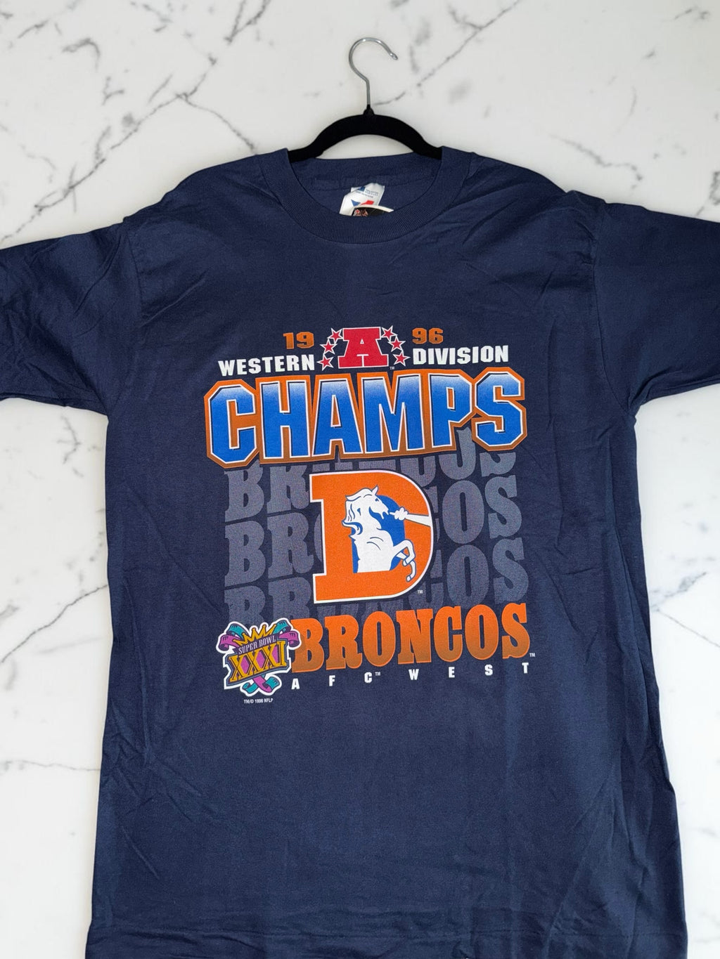 DRIPPING IN VINTY navy blue 1996 Denver Broncos Western Division Champions cotton graphic t-shirt on a hanger