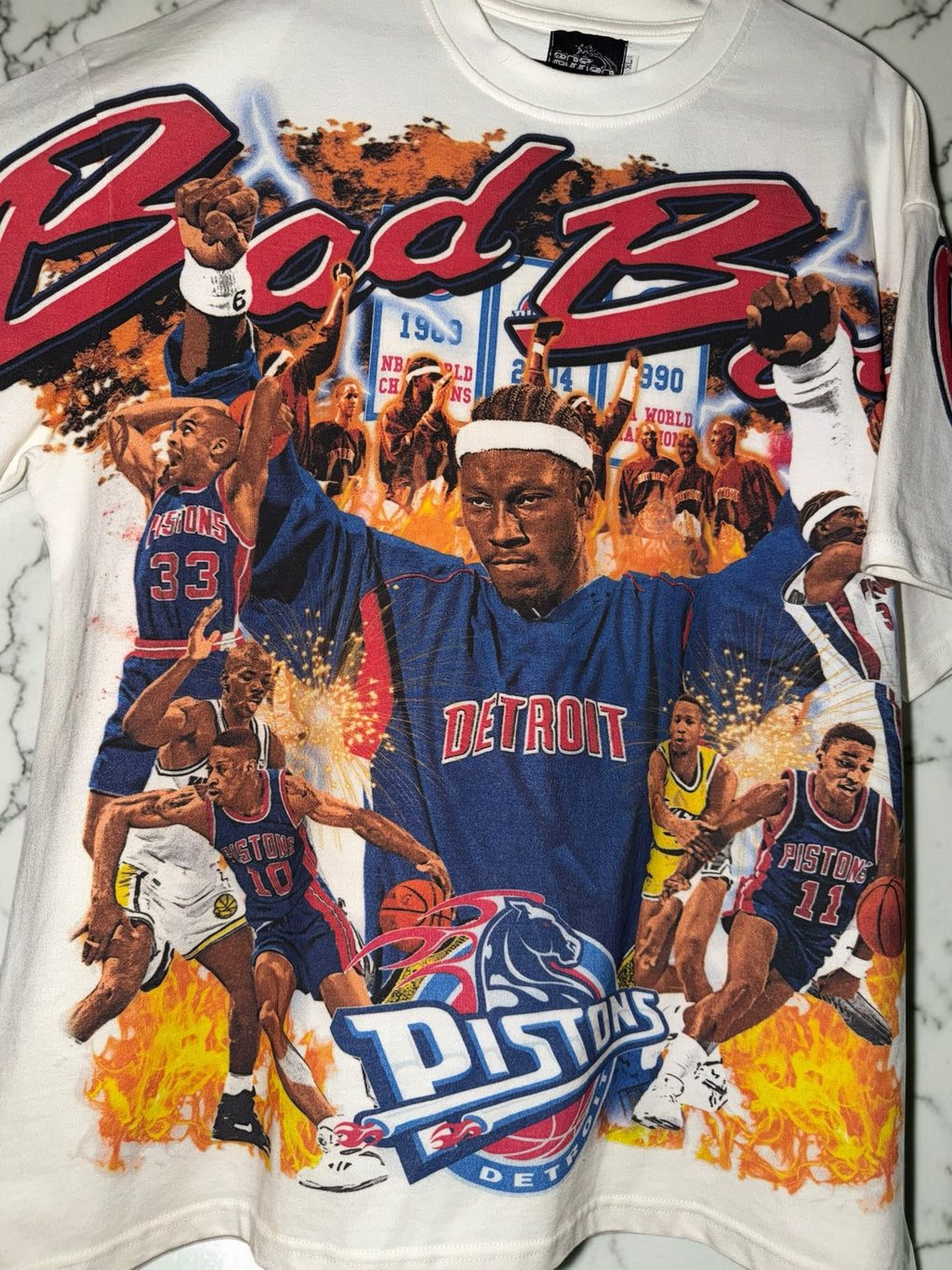 DRIPPING IN VINTY off-white Detroit Pistons graphic t-shirt featuring Bad Boys era basketball players and team logos