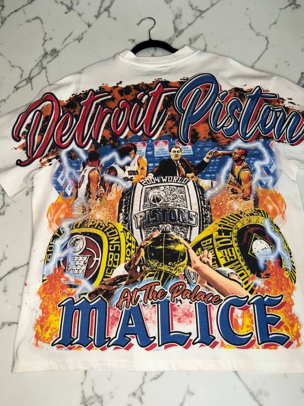 DRIPPING IN VINTY off-white Detroit Pistons vintage-style graphic t-shirt featuring championship rings and team history