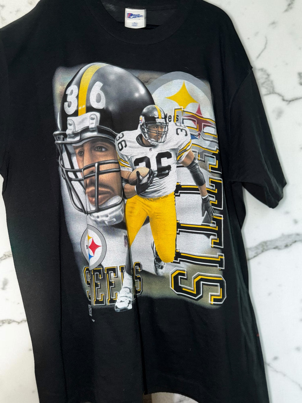 DRIPPING IN VINTY vintage black Pittsburgh Steelers cotton t-shirt with 90s style player graphic and team helmet