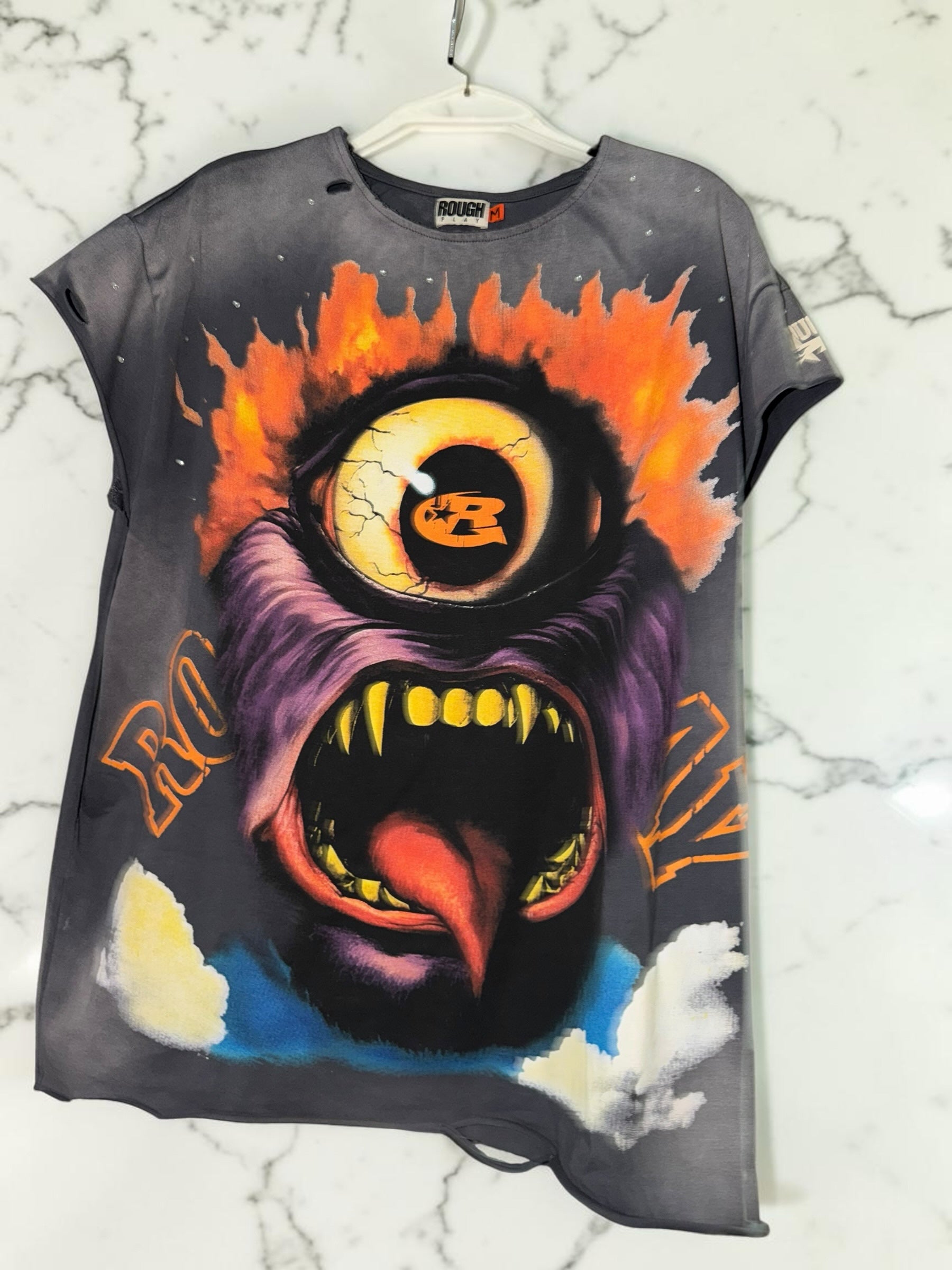 DRIPPING IN VINTY ROUGH PLAY graphic t-shirt with a vibrant monstrous eye print, distressed details, and raw edges.