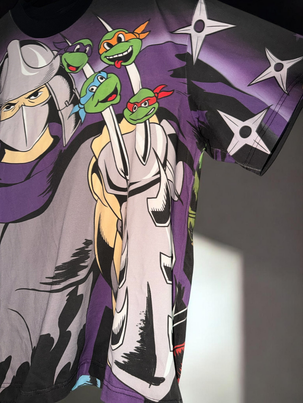 DRIPPING IN VINTY Teenage Mutant Ninja Turtles graphic t-shirt featuring Shredder and the turtles in 90s art style