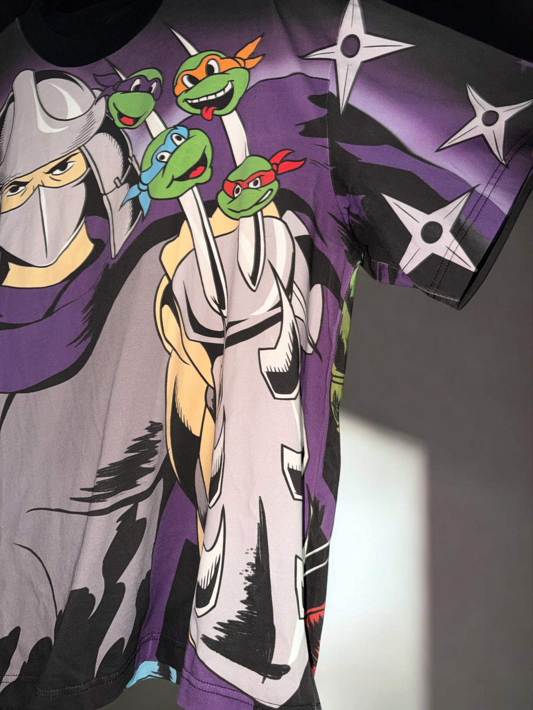DRIPPING IN VINTY Teenage Mutant Ninja Turtles graphic t-shirt featuring Shredder and the turtles in 90s art style